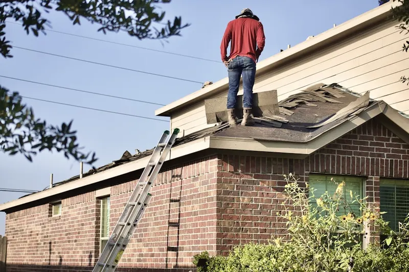 Professional roofer working on a residential roof in Countryside